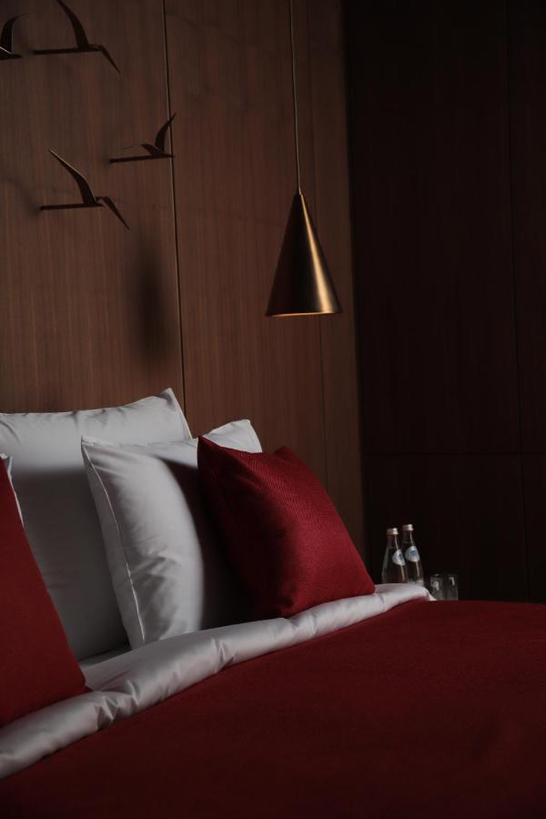 The Veil Hotel Nur-Sultan  Exterior photo A bed with a red pillow